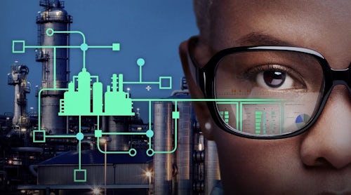 Man wearing glasses peering over schematic with factory in background